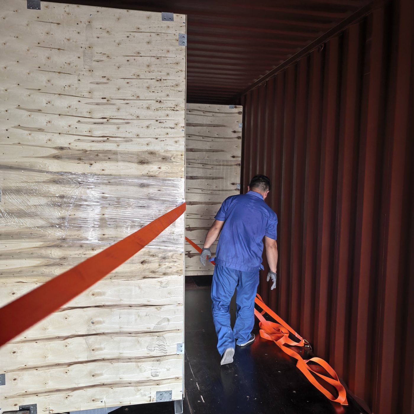Crated outdoor kitchen being secured inside a container